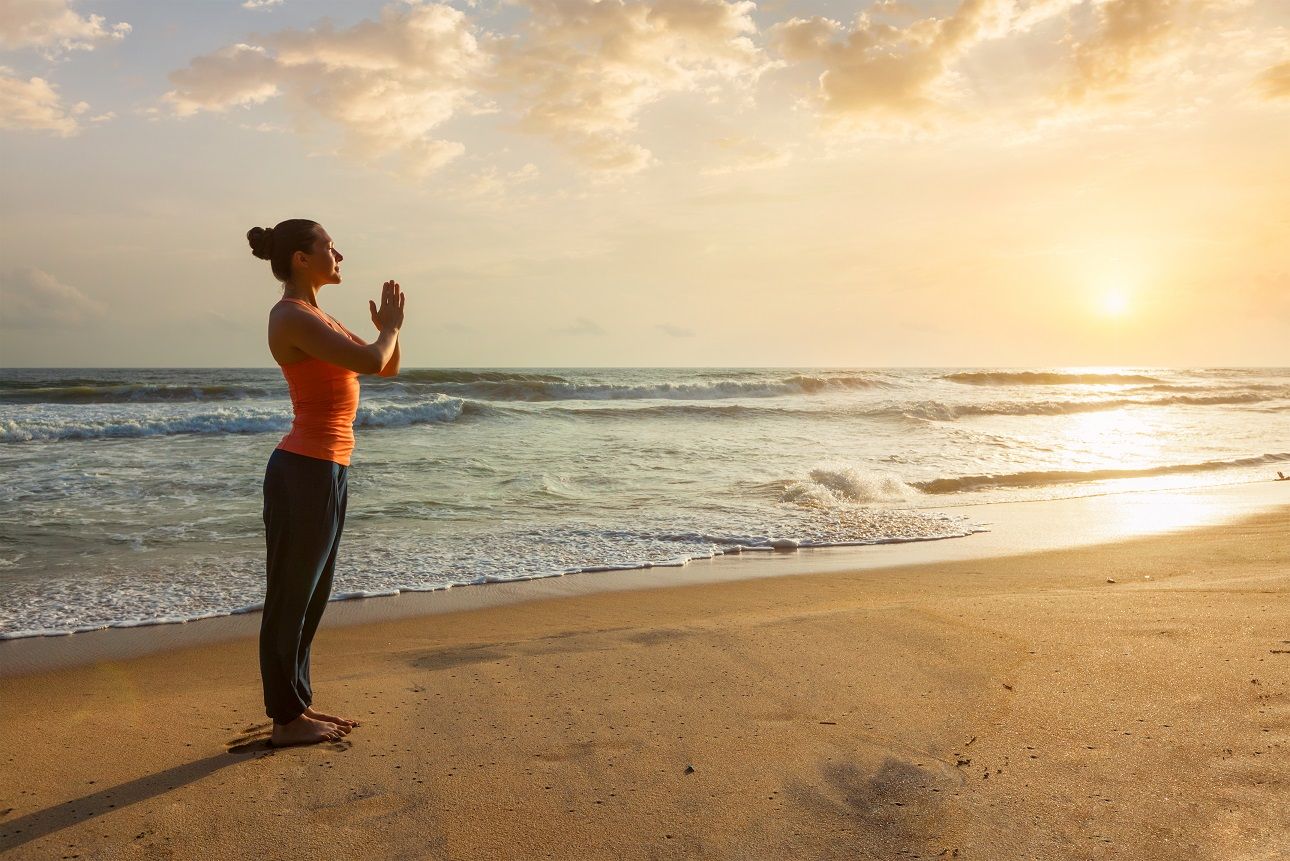 woman-doing-yoga-on-beach-2022-02-02-03-48-23-utc.jpg